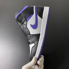 Air Jordan 1 Mid angled view with black upper, white side panel, and purple trim