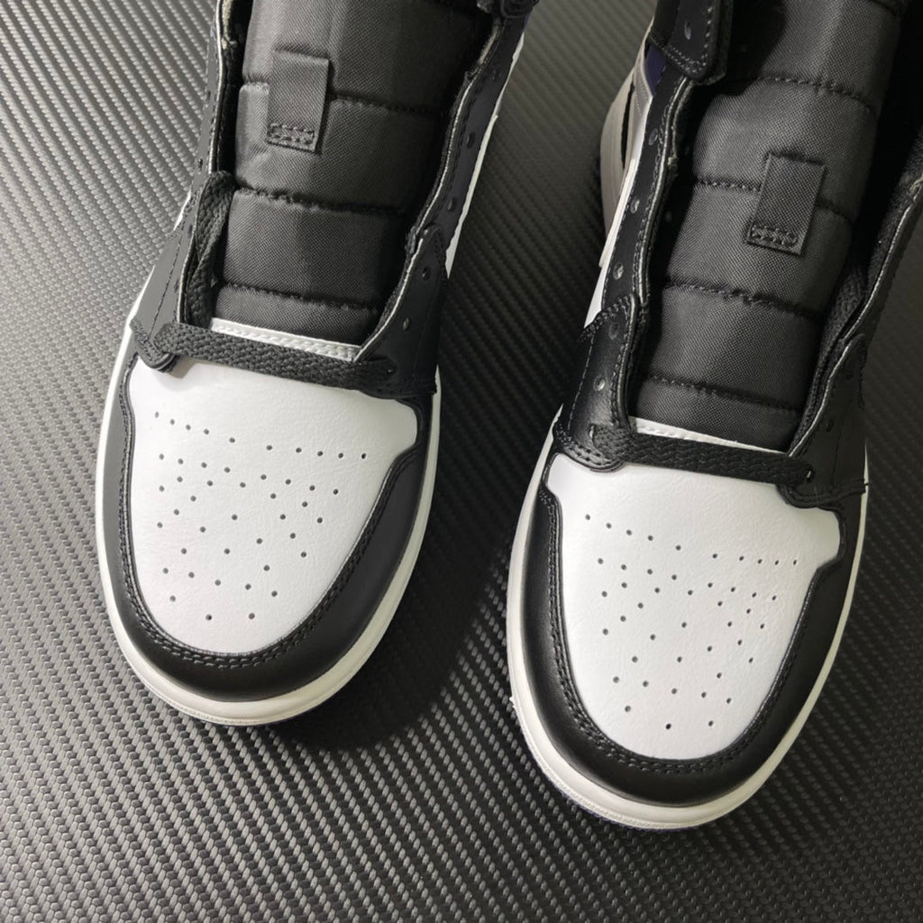 Pair of Air Jordan 1 Mid shoes from front, black sidewalls and white perforated toe
