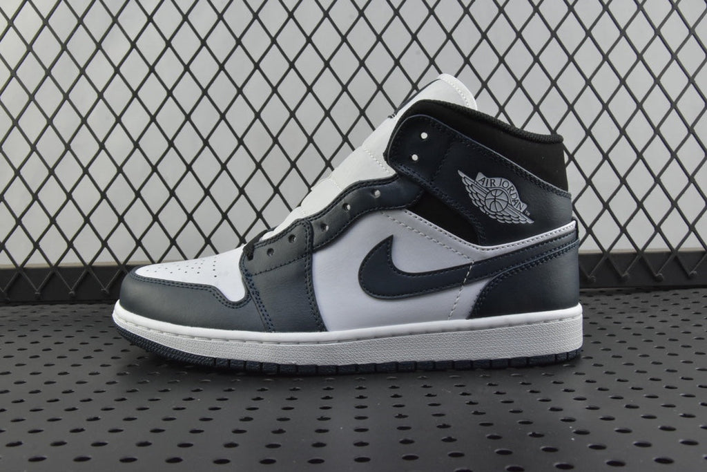 Mid-top sneakers with white panels, dark teal overlays, and black swoosh logo