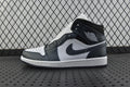 Mid-top sneakers with white panels, dark teal overlays, and black swoosh logo