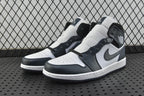 Pair of mid-top sneakers in white, dark teal, and black with lace-up front