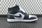 Side view of mid-top sneakers with dark teal collar, white toe panel, and swoosh