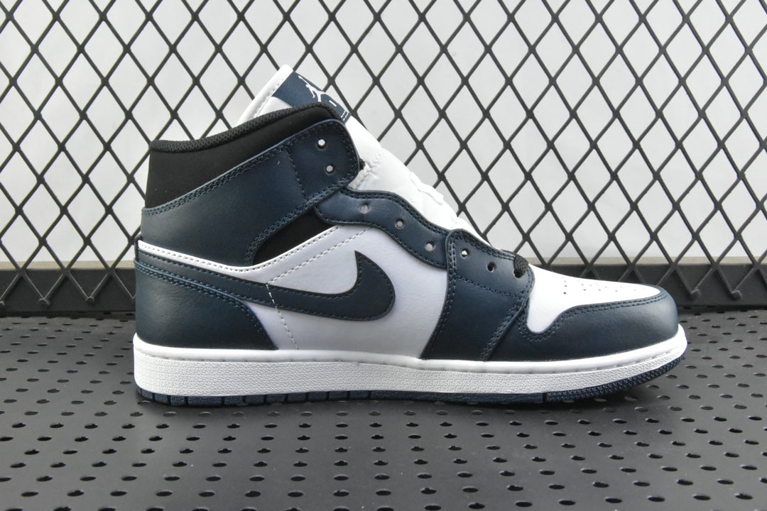 Side view of mid-top sneakers with dark teal collar, white toe panel, and swoosh