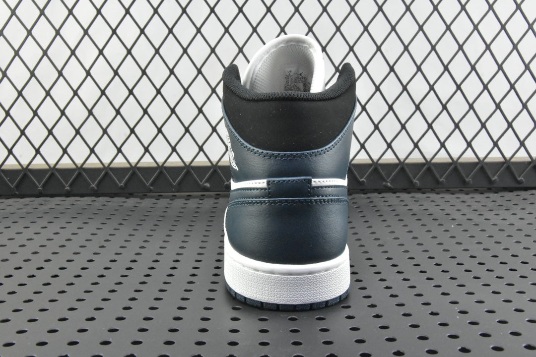 Back view of mid-top sneakers with dark teal heel, white midsole, and padded collar