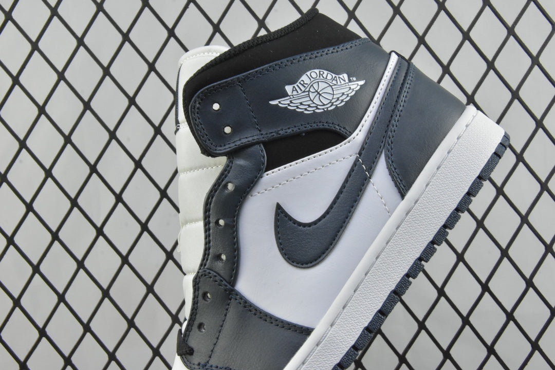 Heel and ankle area of mid-top sneakers with dark teal strap detail and white panels