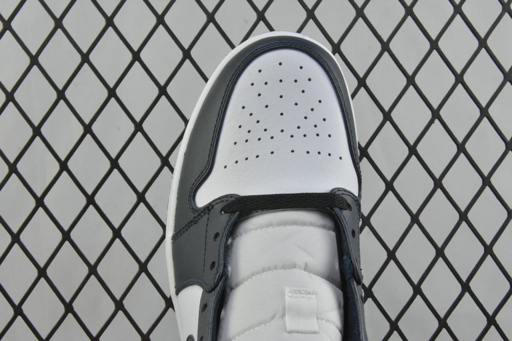 Top view of mid-top sneaker toe box with perforations and dark teal lace eyelets