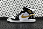 Air Jordan 1 Mid sneakers, black and white with gold swoosh, lace-up mid-top