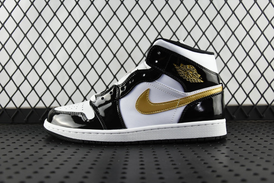 Air Jordan 1 Mid sneakers, black and white with gold swoosh, lace-up mid-top