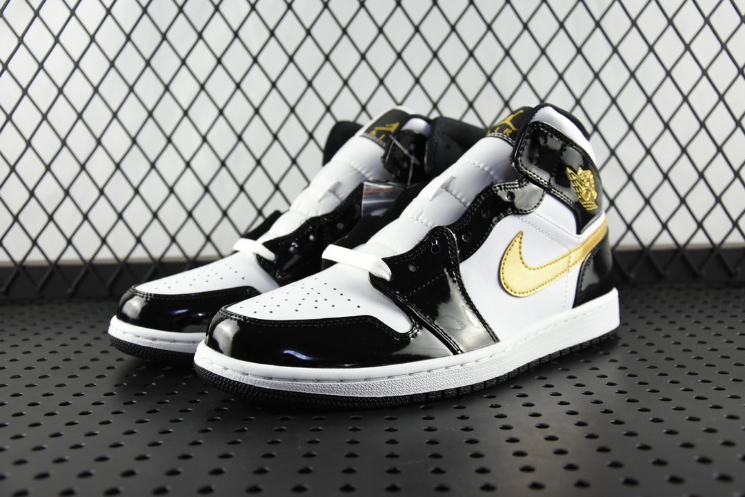 Air Jordan 1 Mid sneakers pair view, black patent and white leather with gold swoosh
