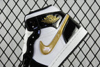 Air Jordan 1 Mid sneaker toe and side close-up, gold emblem, black and white panels