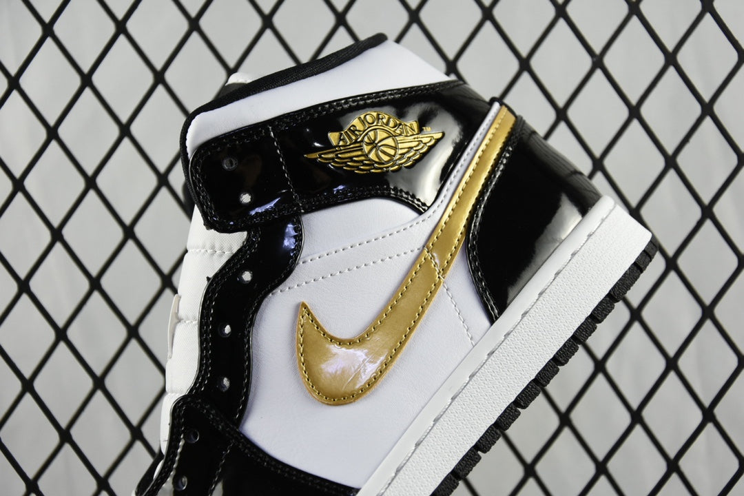 Air Jordan 1 Mid sneaker toe and side close-up, gold emblem, black and white panels