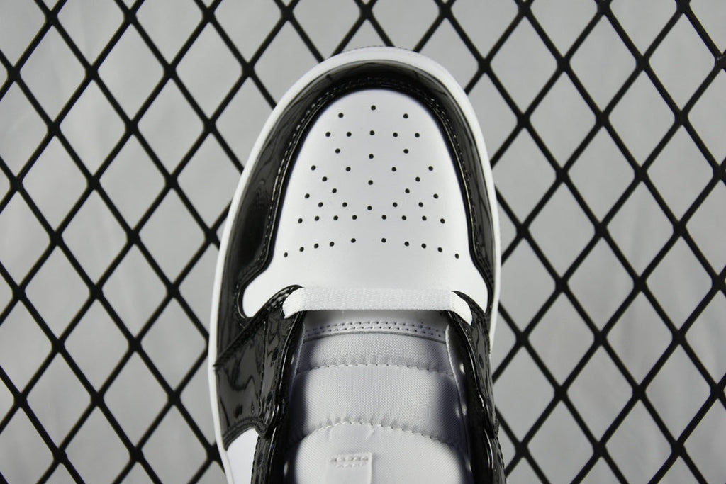 Air Jordan 1 Mid sneaker tongue view, black lining with perforated white toe box