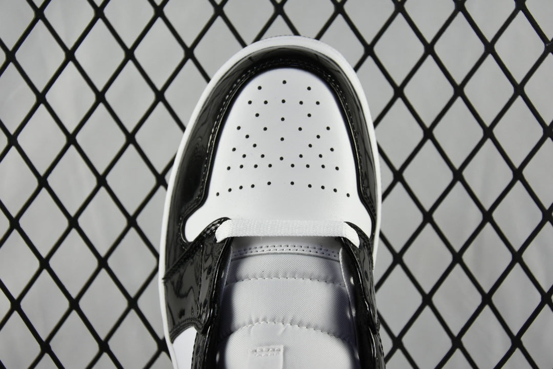 Air Jordan 1 Mid sneaker tongue view, black lining with perforated white toe box