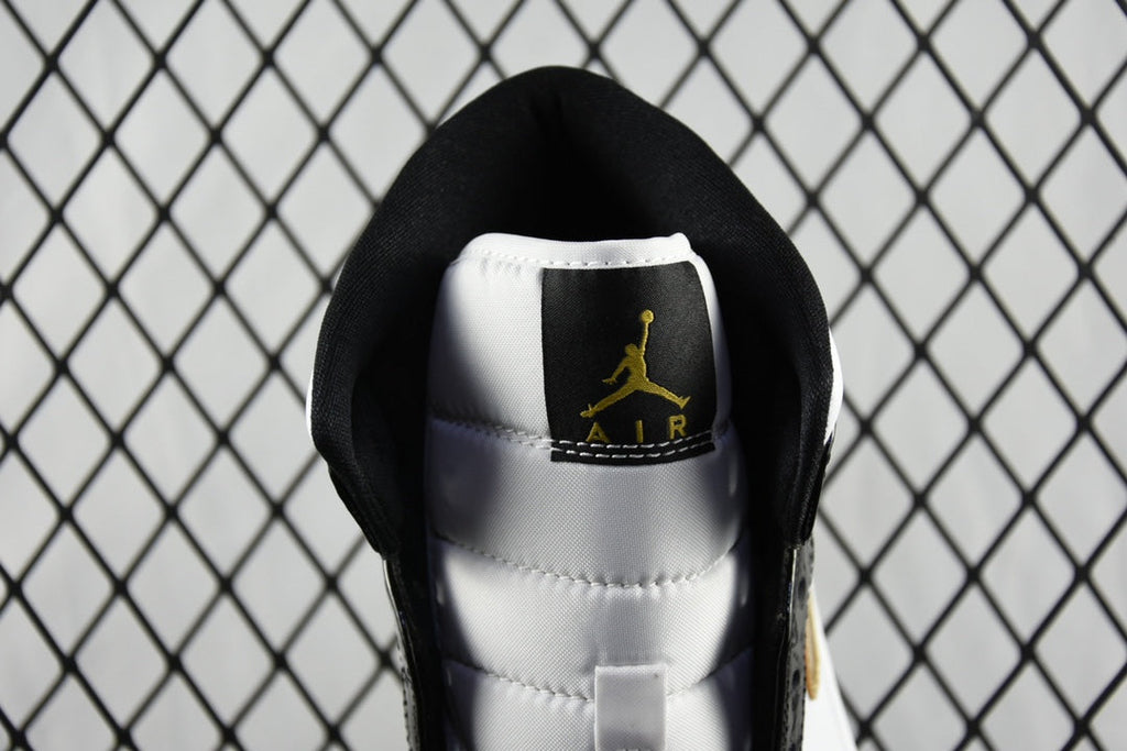 Air Jordan 1 Mid sneaker interior view, black sock liner with gold Air Jordan logo