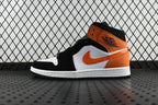 Air Jordan 1 Mid sneakers with black, orange, and white panels and white sole