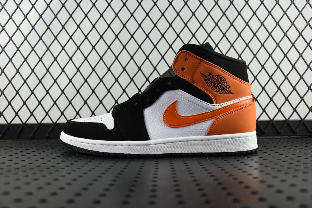 Air Jordan 1 Mid sneakers with black, orange, and white panels and white sole