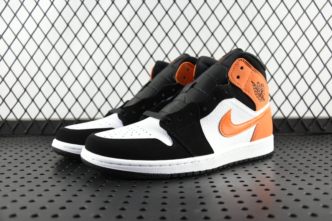 Air Jordan 1 Mid sneakers, black and orange with white side swoosh and midsole