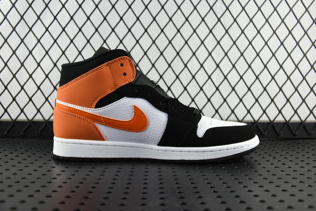 Air Jordan 1 Mid sneakers with orange collar, white panel, and black leather upper