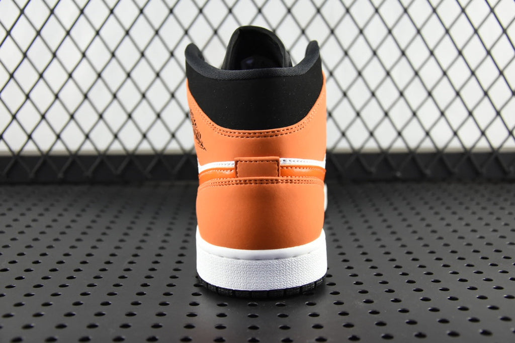 Air Jordan 1 Mid sneakers, rear view with black collar and orange heel panel