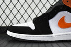 Air Jordan 1 Mid sneakers close-up with black upper, white toe panel, orange swoosh