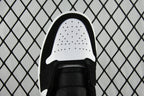 Air Jordan 1 Mid sneaker toe view with black upper, white perforated toe box