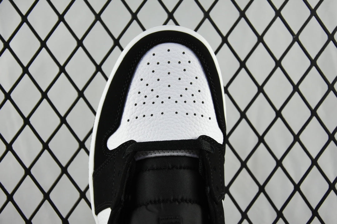 Air Jordan 1 Mid sneaker toe view with black upper, white perforated toe box