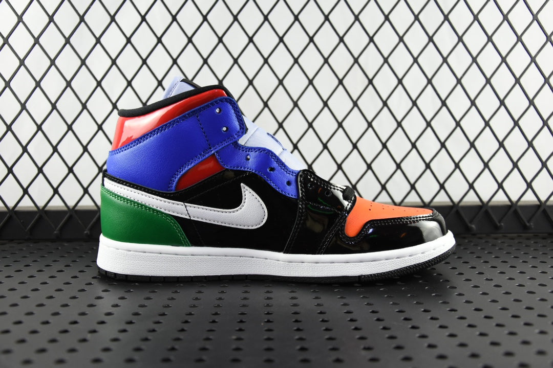 Mid-top sneaker with blue, black, orange toe, white swoosh, and green accent