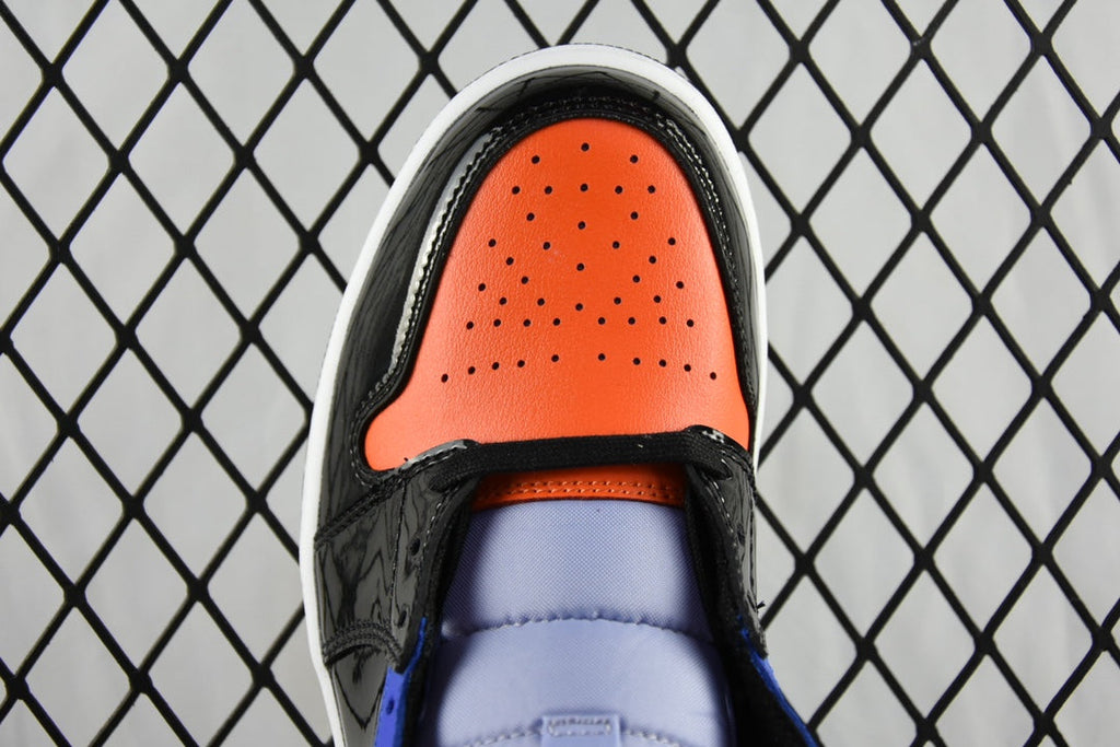 Mid-top sneaker toe cap with orange perforated panel, blue quarter, and black overlay