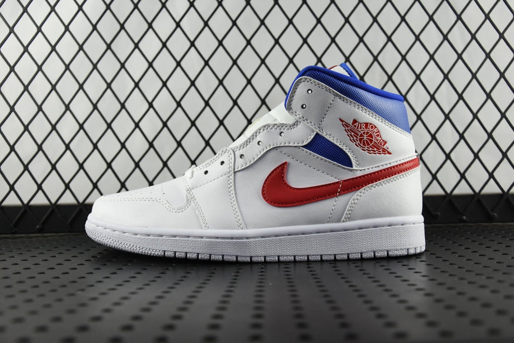 White mid-top sneakers with blue panels, red swoosh, and blue tongue lining.