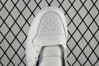 White perforated toe cap with front seam and lace eyelets.