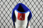 White sneaker heel with blue collar lining and red Air logo patch.