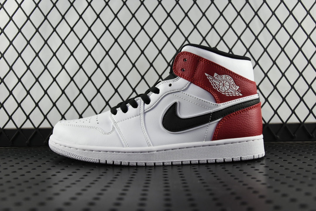 Mid-top sneaker with white leather upper and red ankle panel, black swoosh