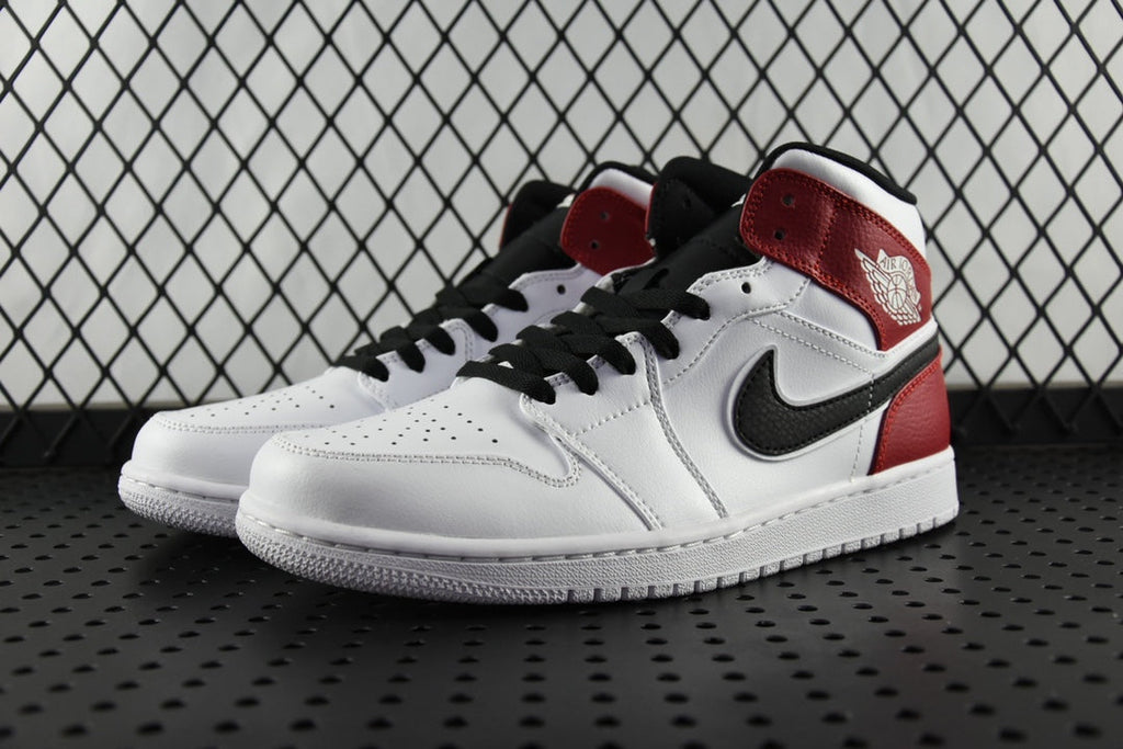 Mid-top sneaker, white upper with red heel and black laces, side view