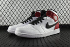Mid-top sneaker, white upper with red heel and black laces, side view