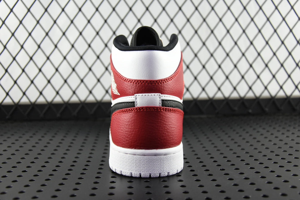 Mid-top sneaker heel view with red and white panels, black lining