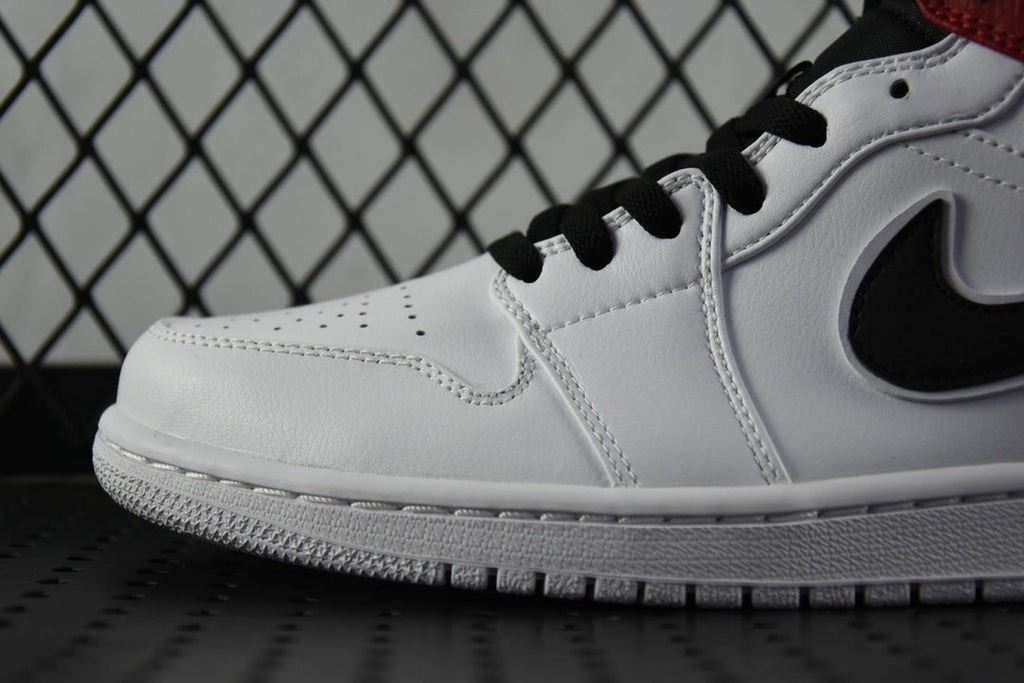 White leather mid-top sneaker close-up with black laces and swoosh