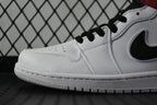 White leather mid-top sneaker close-up with black laces and swoosh