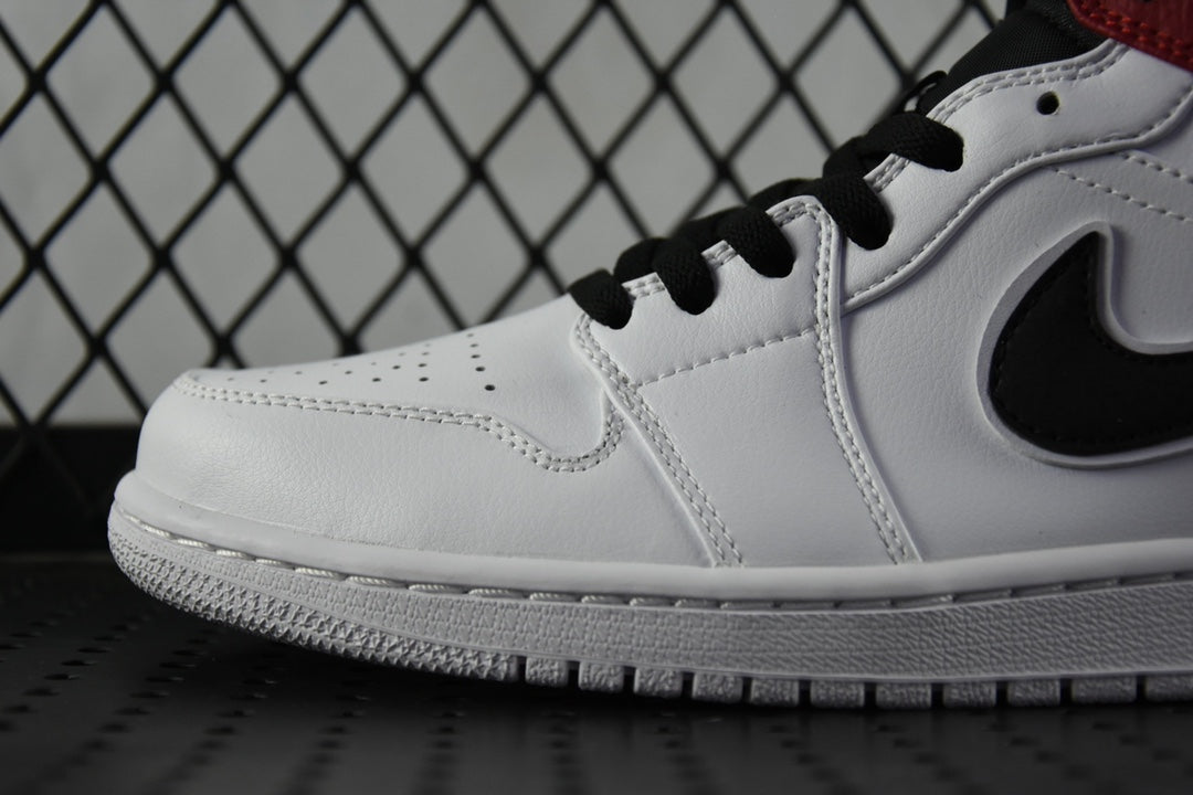 White leather mid-top sneaker close-up with black laces and swoosh