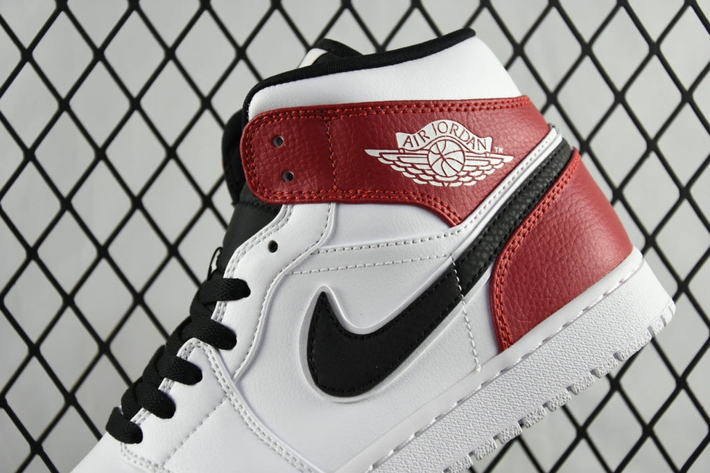 Mid-top sneaker close-up of ankle strap with Air Jordan logo, black laces
