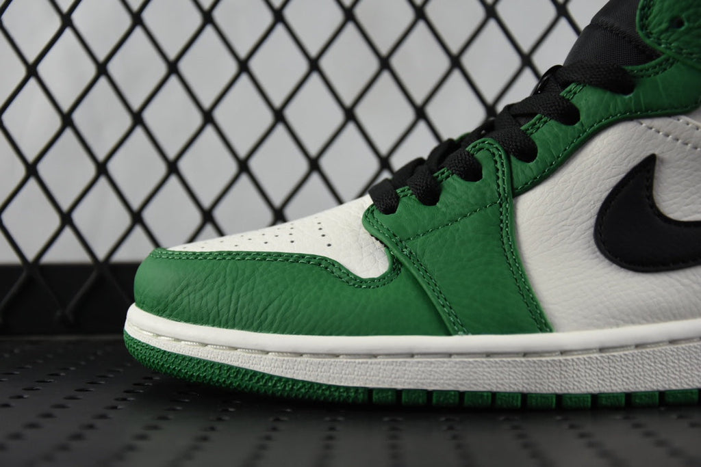 Air Jordan 1 Mid green and white sneaker detail with black swoosh and stitching