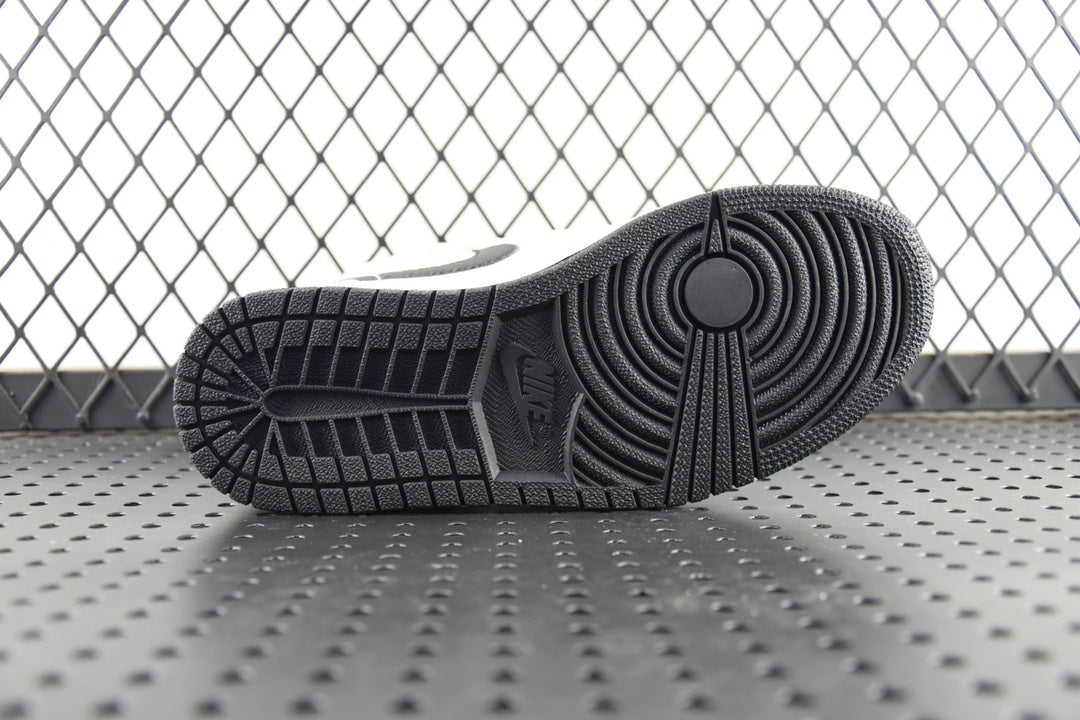 Air Jordan 1 Mid outsole, textured black rubber tread bottom view