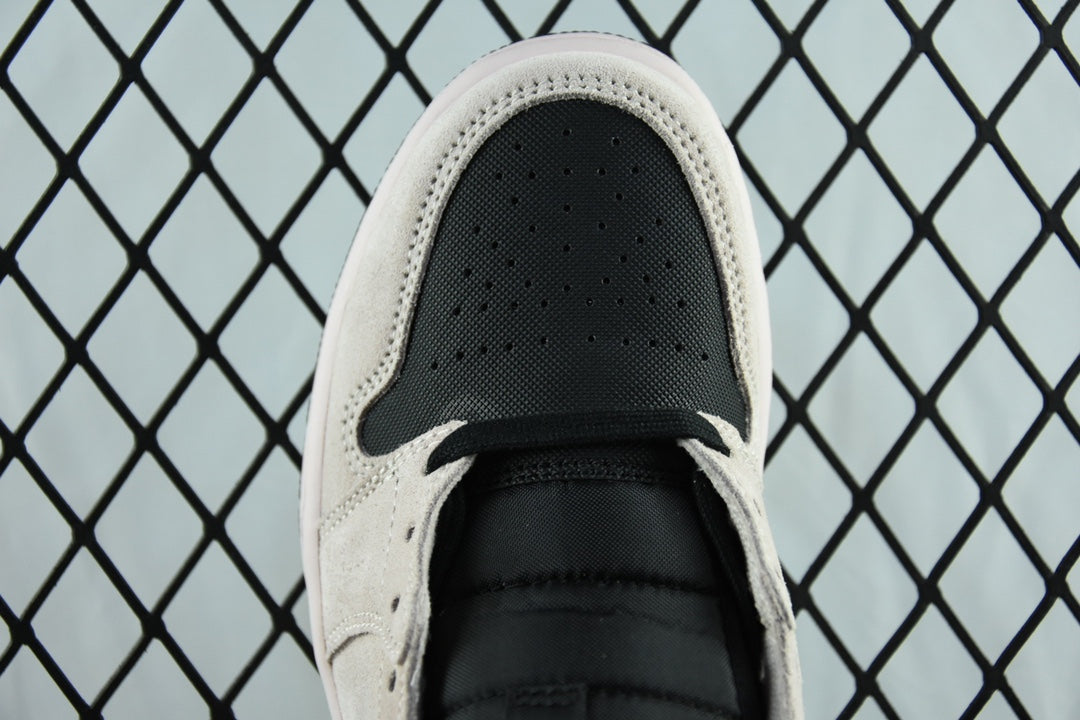 Air Jordan 1 Mid sneaker toe view, perforated light gray upper with black swoosh