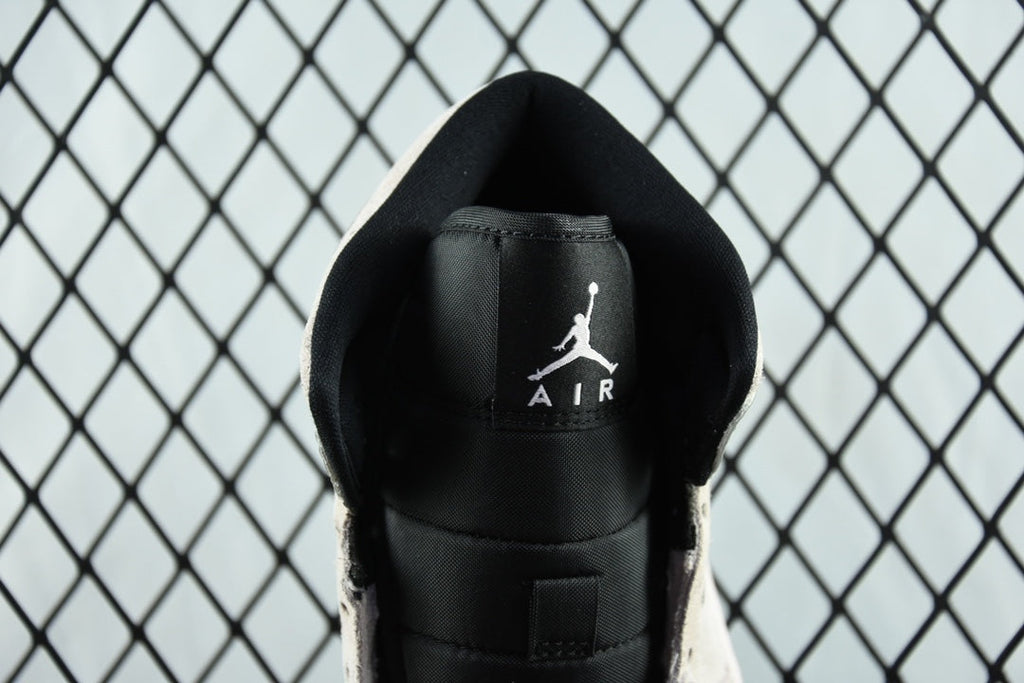 Air Jordan 1 Mid heel close-up, black backing with Air logo and AIR text