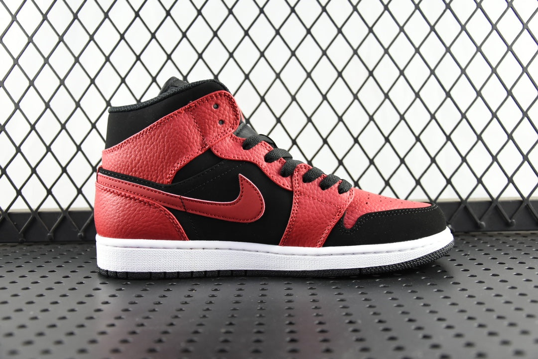 Mid-top leather sneaker in red and black with swoosh side panel and black laces