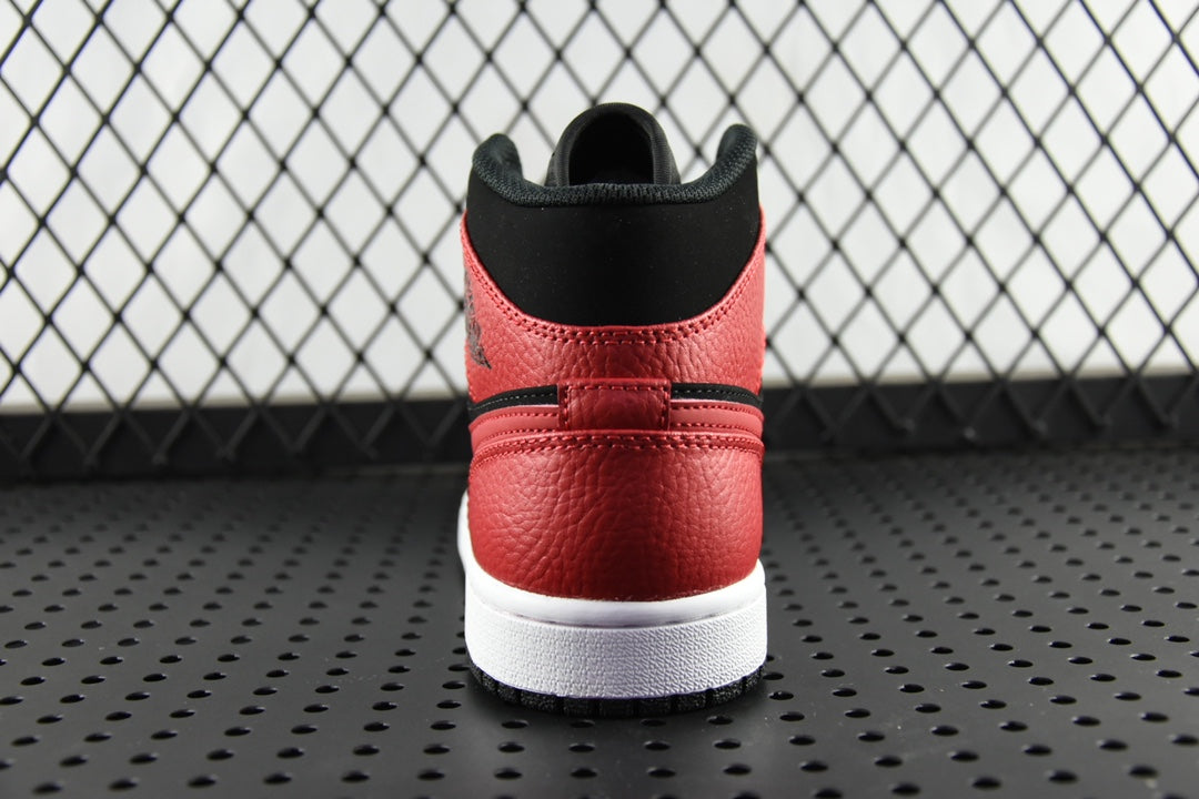 Heel view of red and black mid-top sneaker with white rubber sole