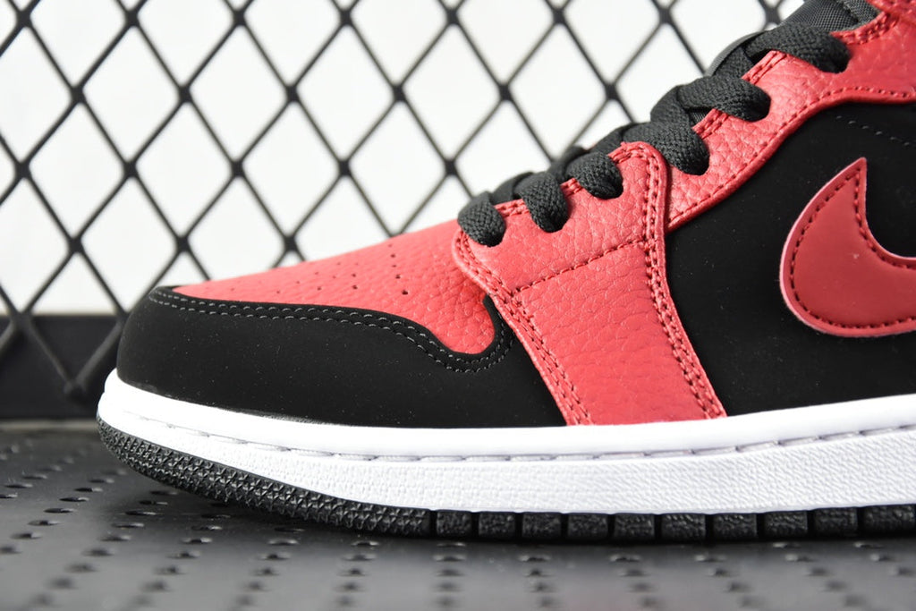 Side view of red and black mid-top sneaker with black swoosh and white midsole
