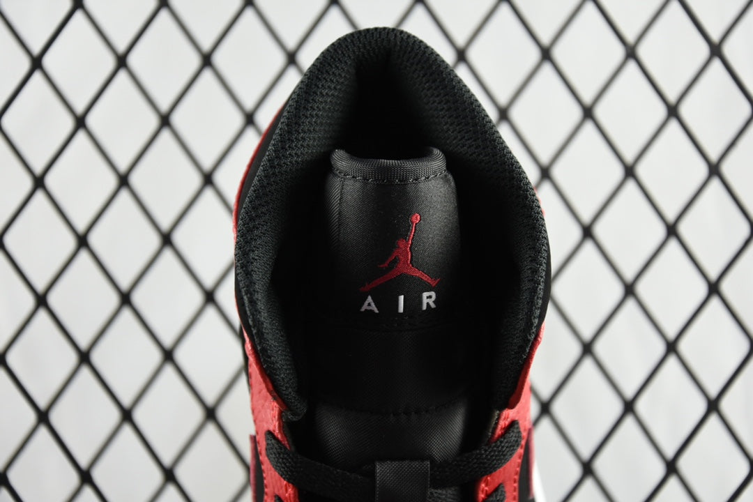 Inside heel view of black insole with red Jumpman logo on mid-top sneaker