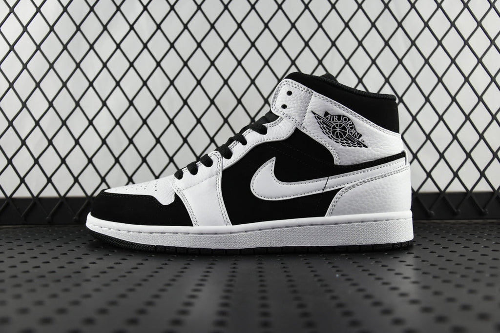 Black and white mid-top sneakers with lace-up, Nike Swoosh on side, Air Jordan logo