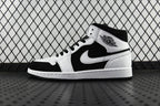 Black and white mid-top sneakers with lace-up, Nike Swoosh on side, Air Jordan logo