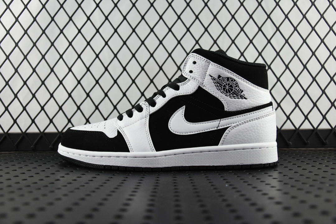 Black and white mid-top sneakers with lace-up, Nike Swoosh on side, Air Jordan logo